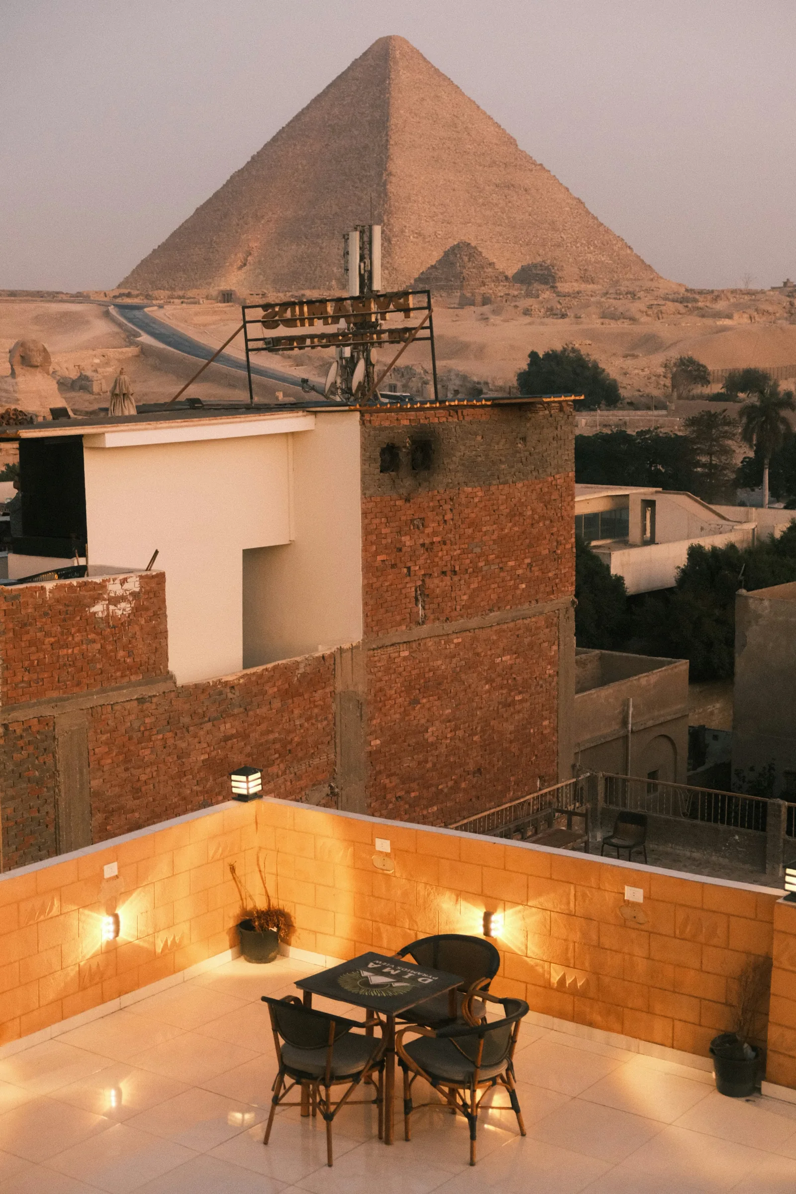 The Great Pyramid Seen From A Rooftop Terrace At Dusk